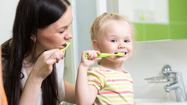 Mother & Daughter Brushing Teeth