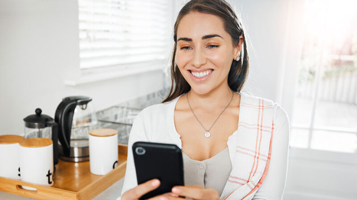 smiling woman selfie phone kitchen
